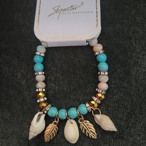 Women's seashell and leaf and beaded bracelet.